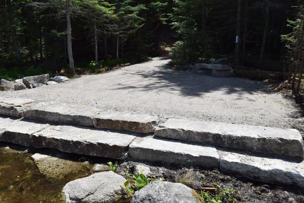 This photo of the granite steps at the remote Pond of Safety that drains north to the Upper Ammonoosuc River watershed was shot from one of the temporary hay bales that will be removed once the possibility of erosion and sedimentation has passed. It took time, patience and skill for each slab to be put securely in place. (Photo by Edith Tucker.)